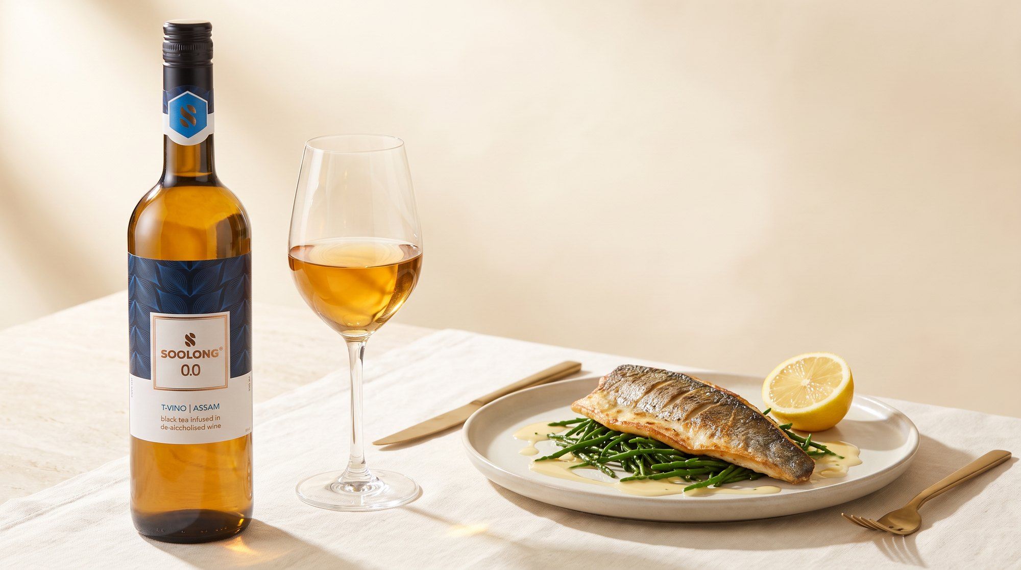 T-Vino Assam with a glass of wine and sea bass on a white table